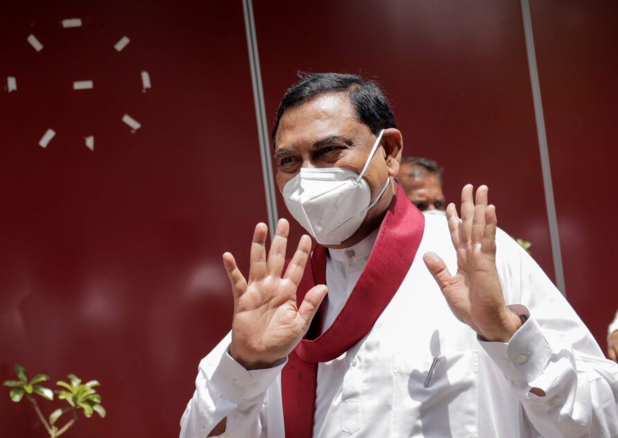 Basil Rajapaksa gestures as he leaves in Colombo